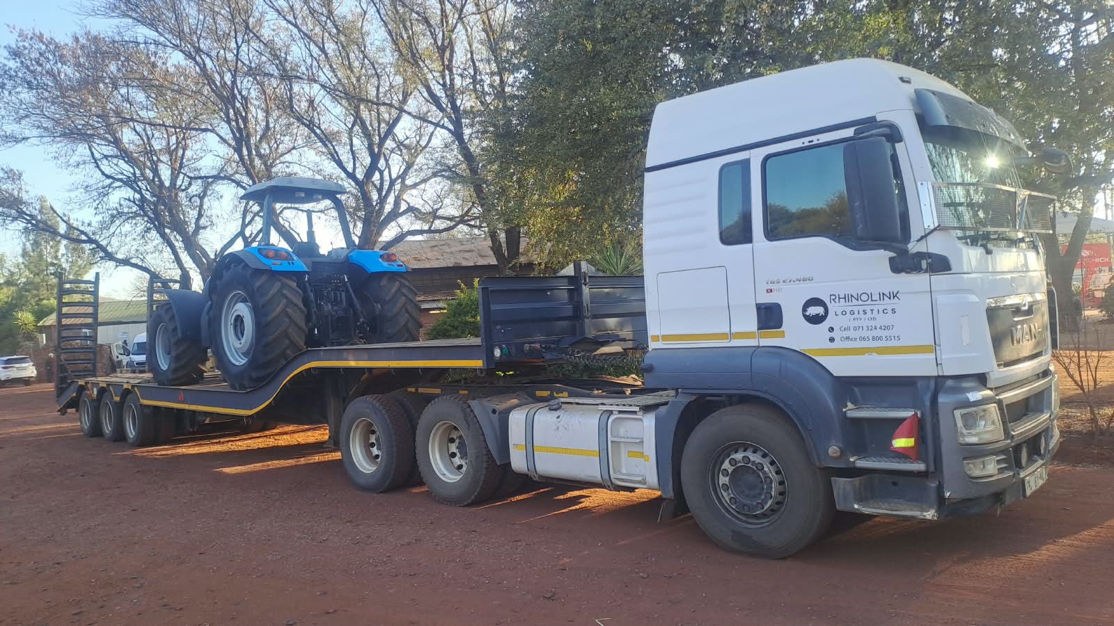 Tractor loaded on a low-bed trailer