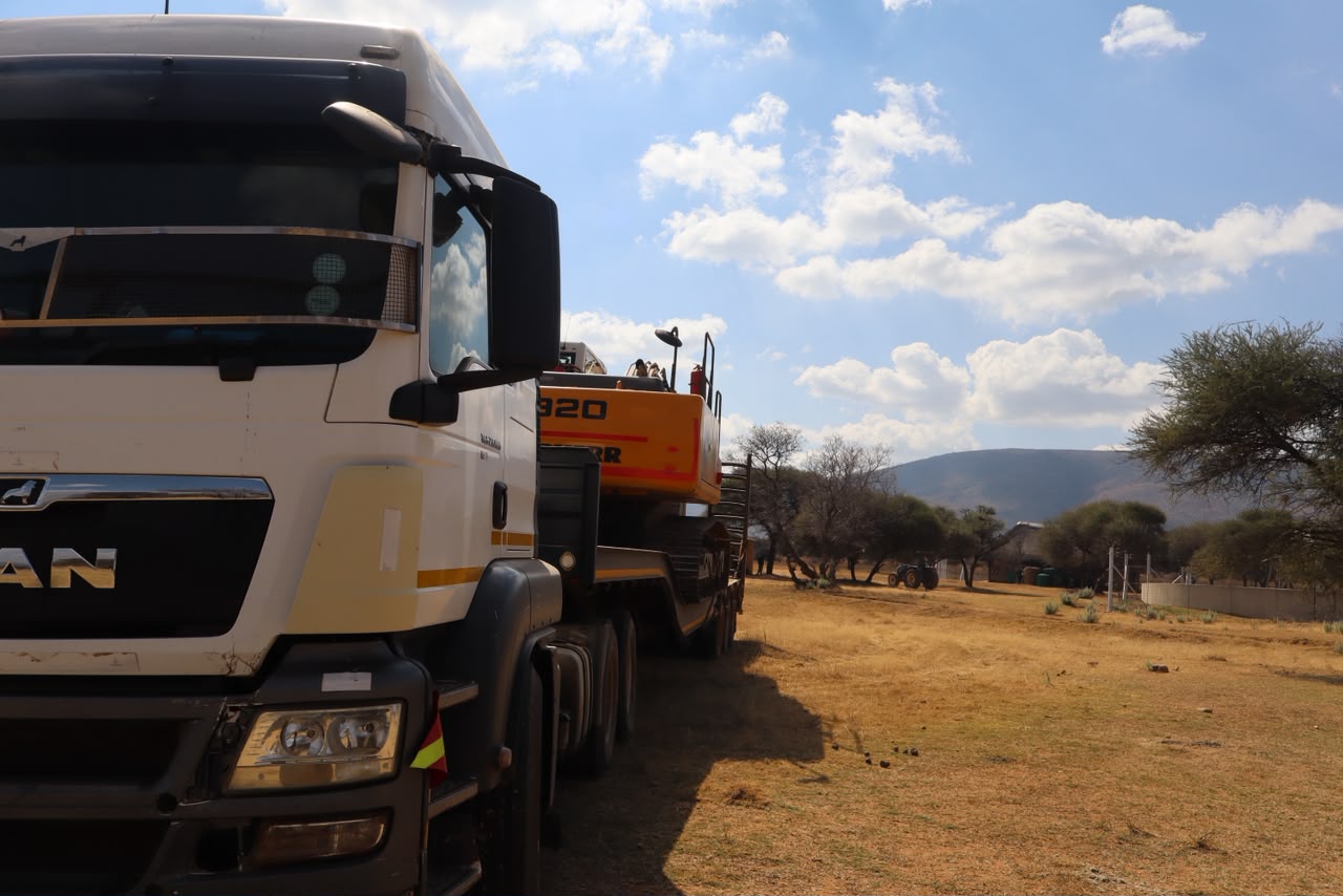 Truck carrying heavy equipment